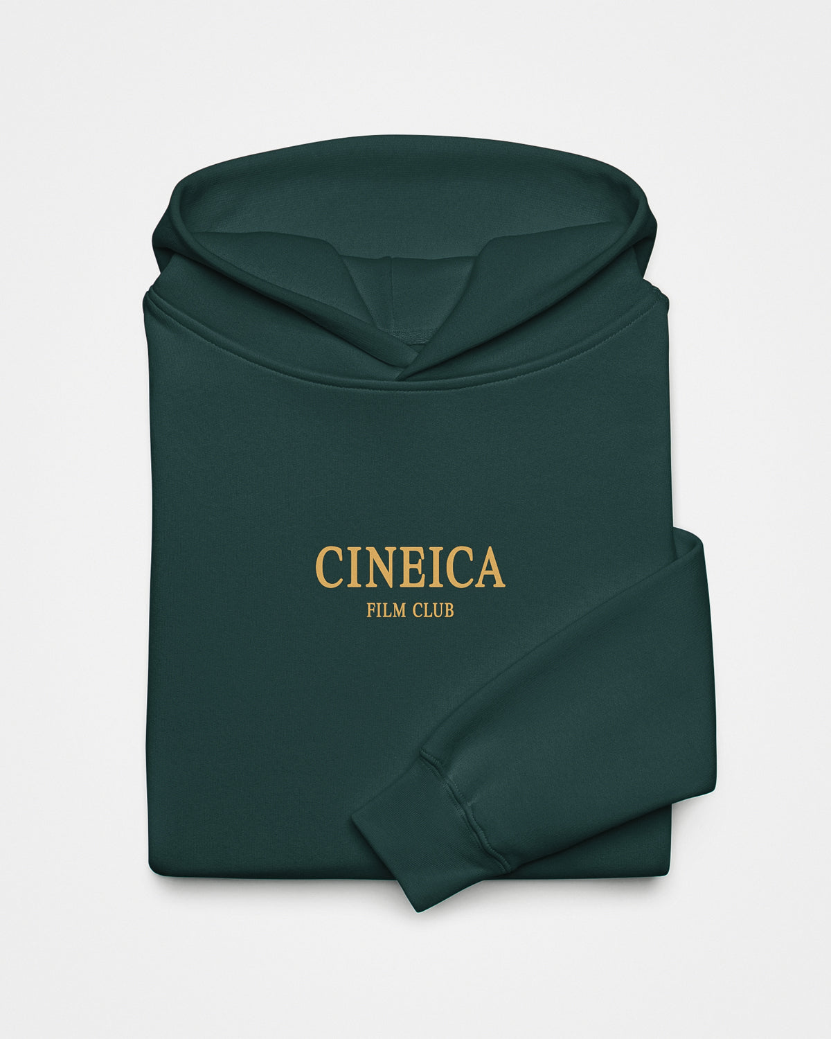 Closeup of the front of a green folded hoodie with yellow text. The text says "CINEICA FILM CLUB" across the chest.