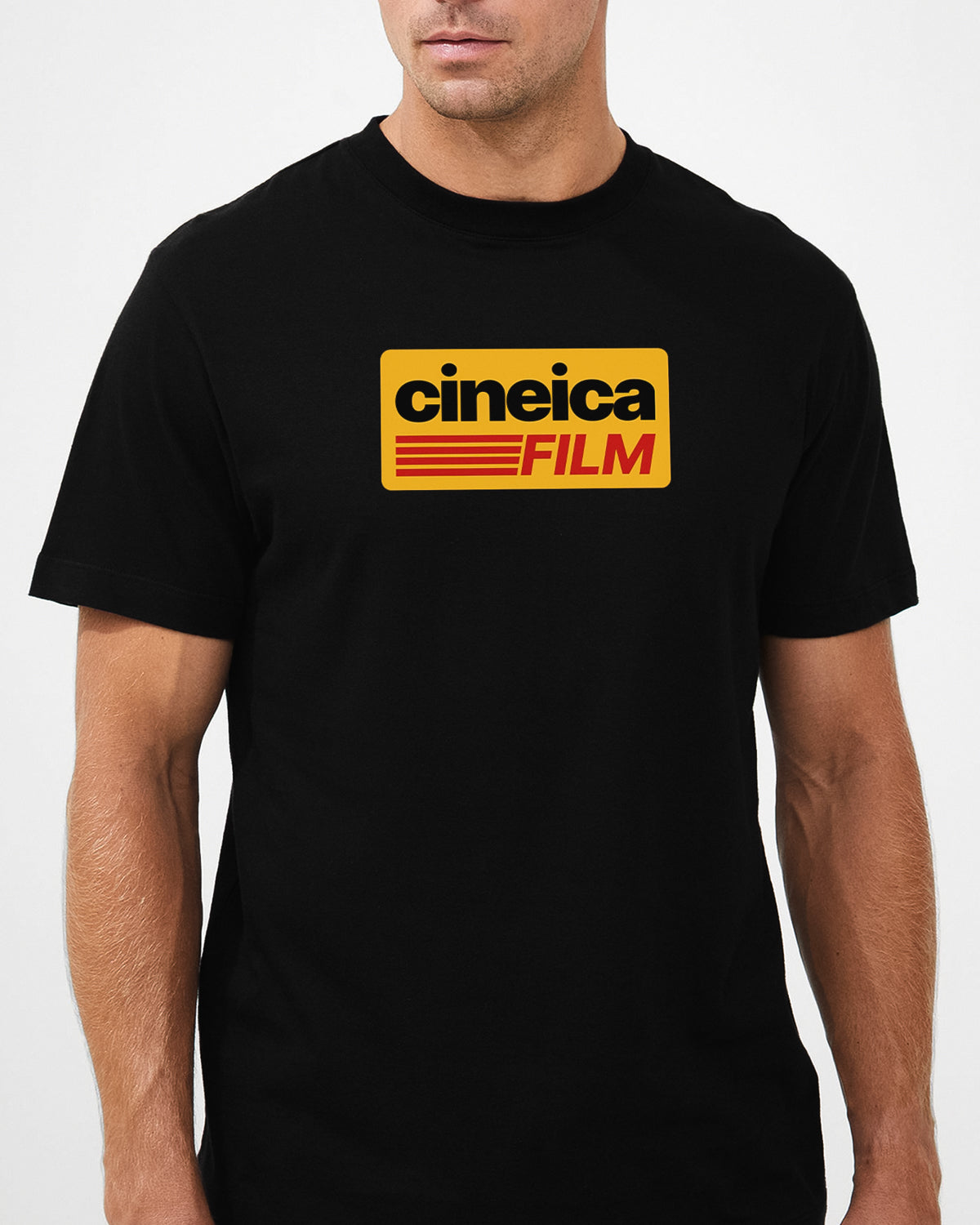 A man wearing a black film photography t-shirt with vintage Kodak-styled graphic and text "cineica FILM".