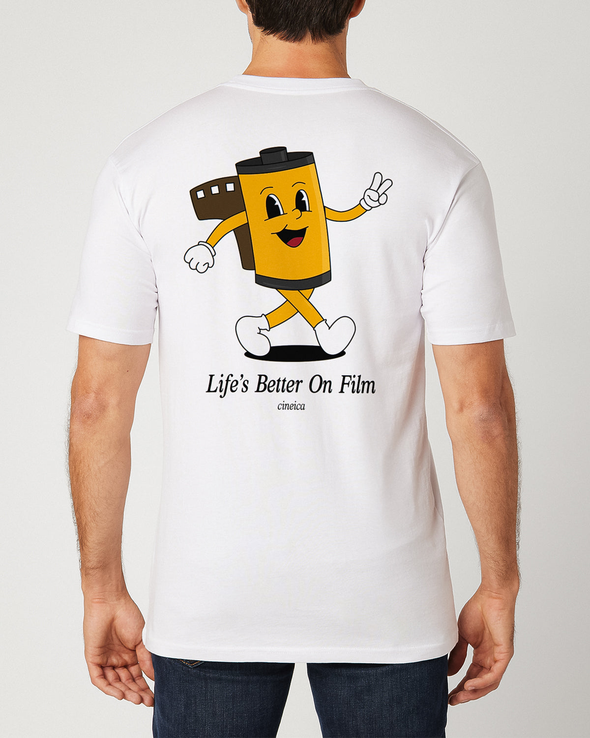 Back of man wearing a white t-shirt with a 35mm film canister cartoon character and the text "Life's Better On Film".