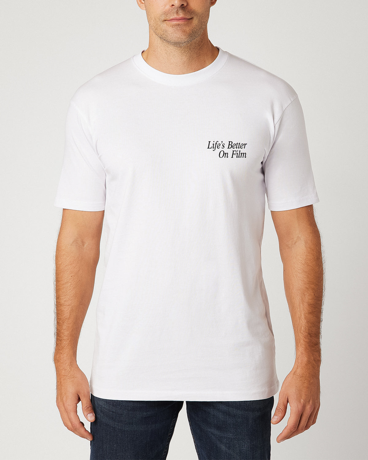 Front of a man wearing a white t-shirt with the text "Life's Better On Film".