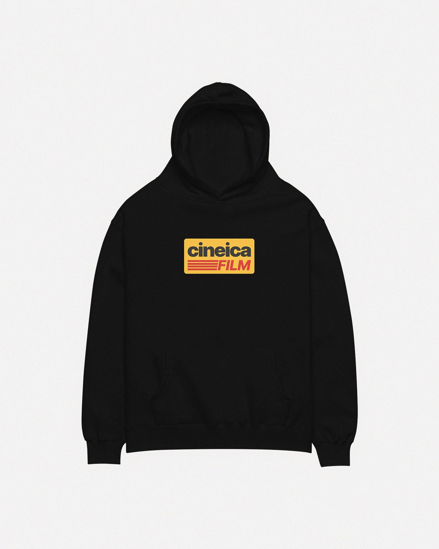 Photo of a black cineica hoodie front. The design features a yellow graphic with black and red text in a vintage style, the text states "cineica FILM".