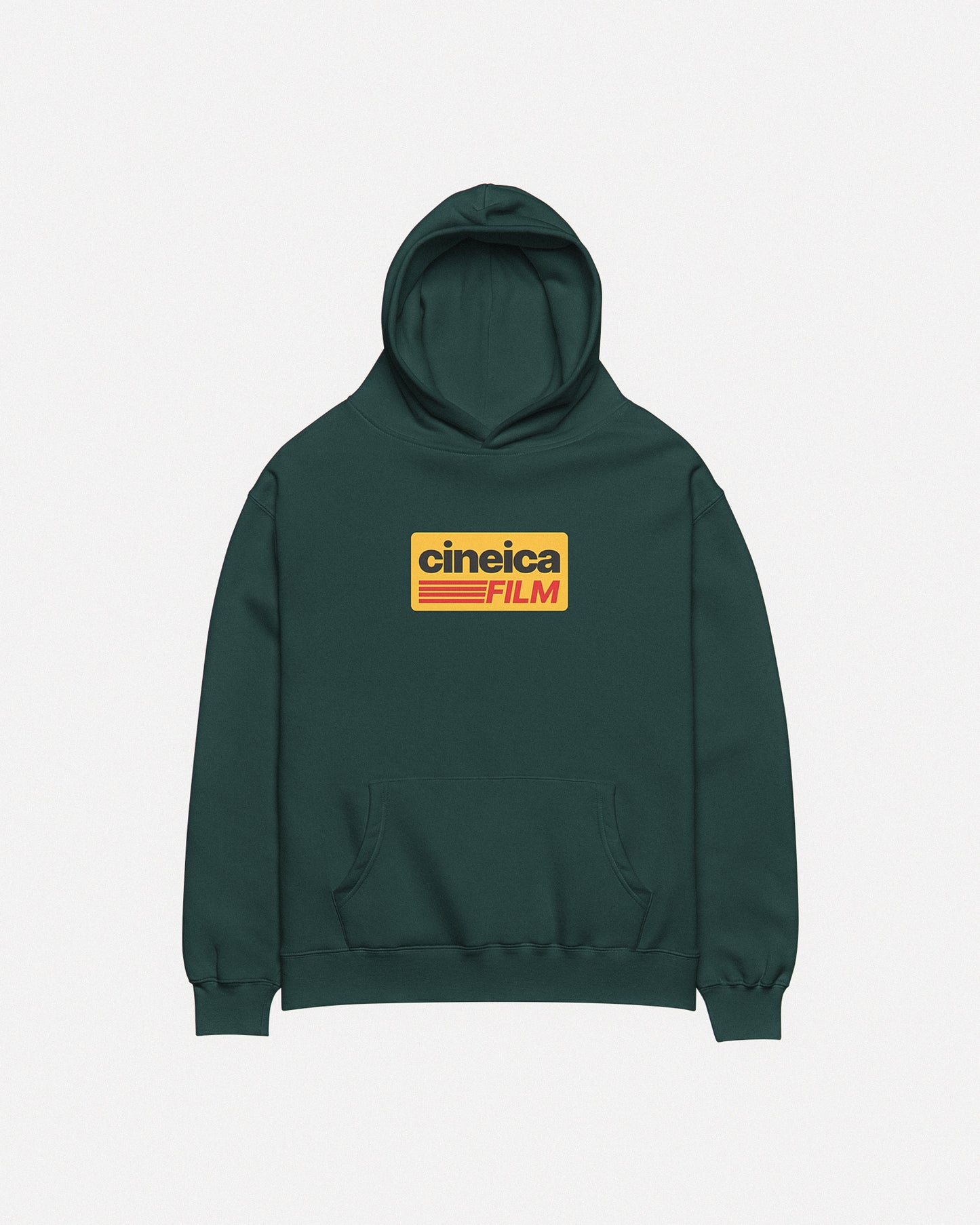 Photo of a green cineica hoodie front. The design features a yellow graphic with black and red text in a vintage style, the text states "cineica FILM".