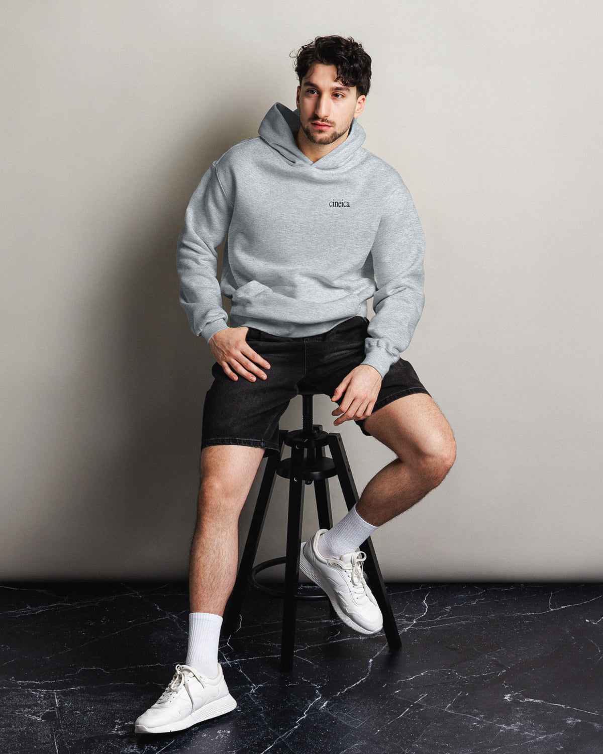 Photo of a man wearing a gray cineica hoodie.