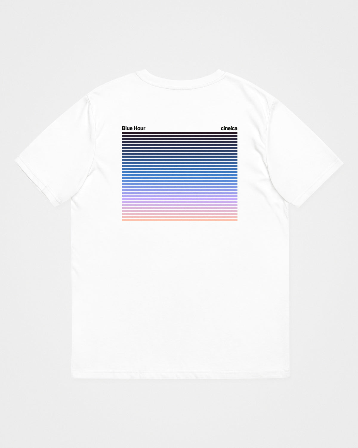 A white t-shirt with text "Blue Hour" and "cineica" followed by a gradient of the dusk sky.