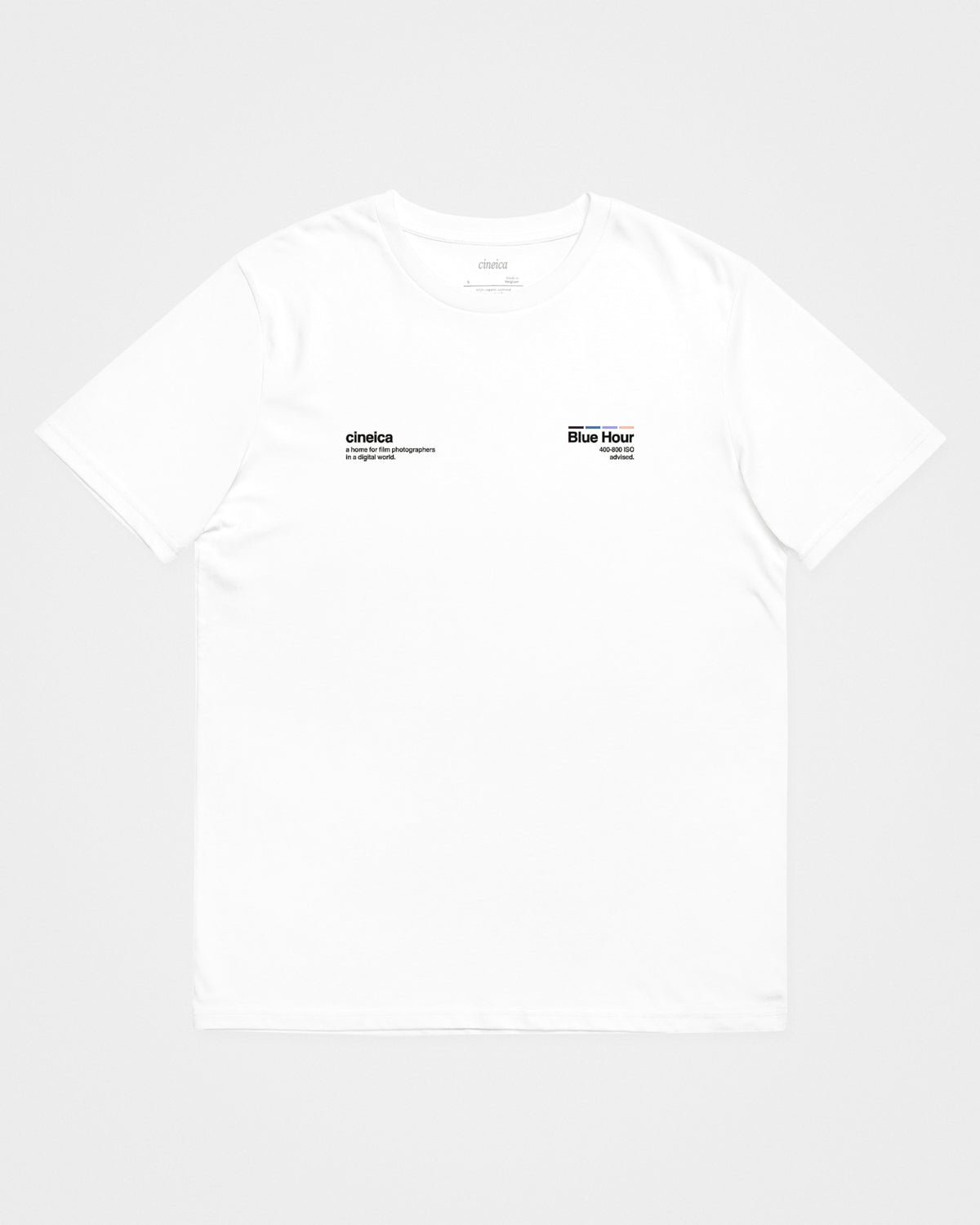 A white t-shirt with text "cineica, a home for film photographers in a digital world." and "Blue Hour, 400-800 ISO advised.".