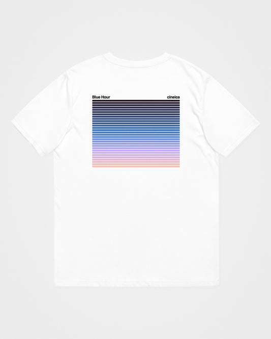 A white t-shirt with text "Blue Hour" and "cineica" followed by a gradient of the dusk sky.
