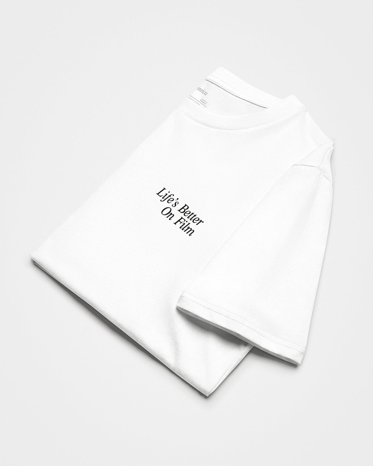 Front of a folded white t-shirt with the text "Life's Better On Film".